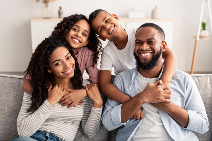 happy black couple with two kids