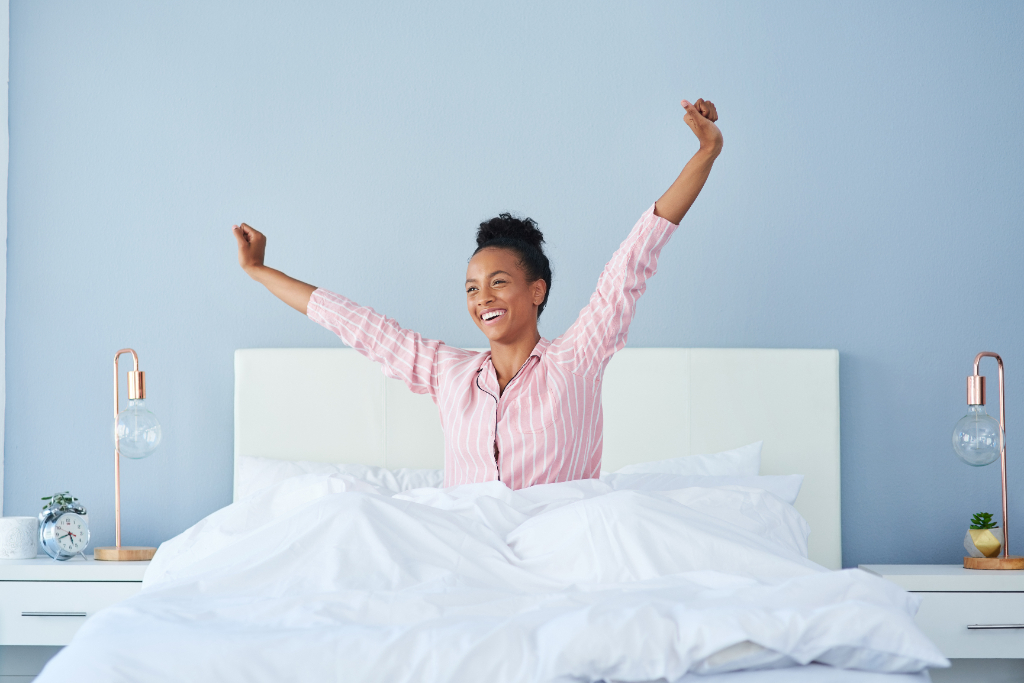 woman wearing pink pajamas waking up